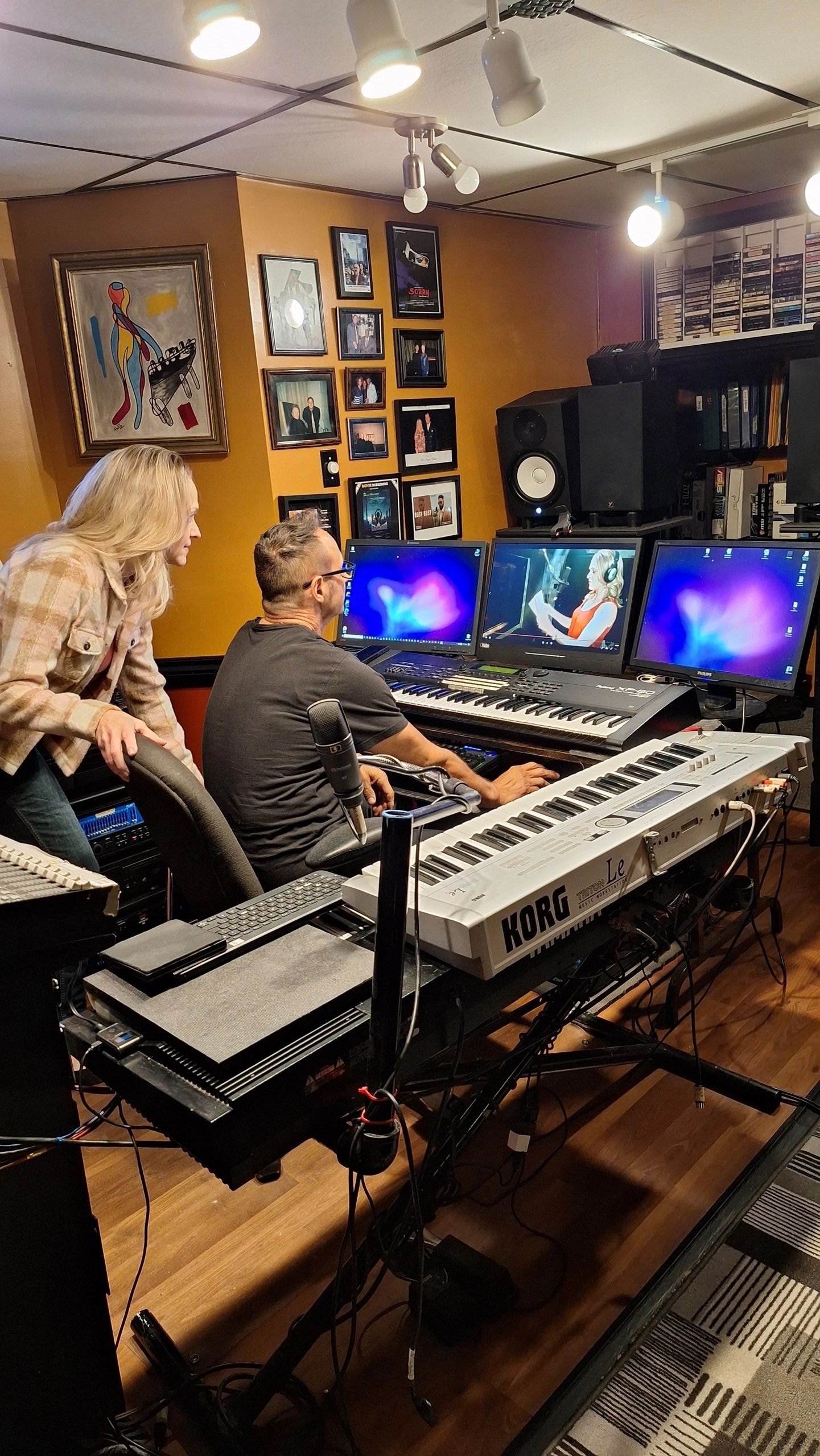 Joanne and producer working at music studio with KORG keyboard and monitors