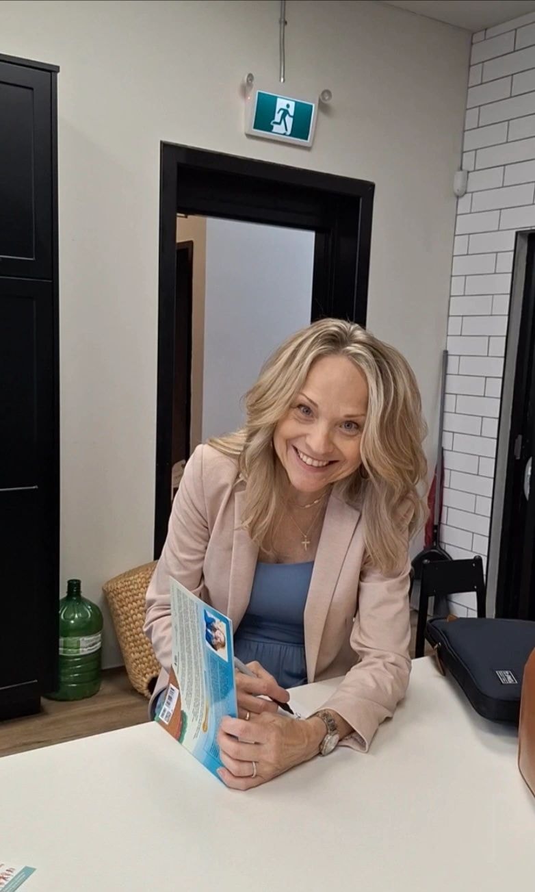 Joanne signing a book at Rose City Kids in Welland Ontario