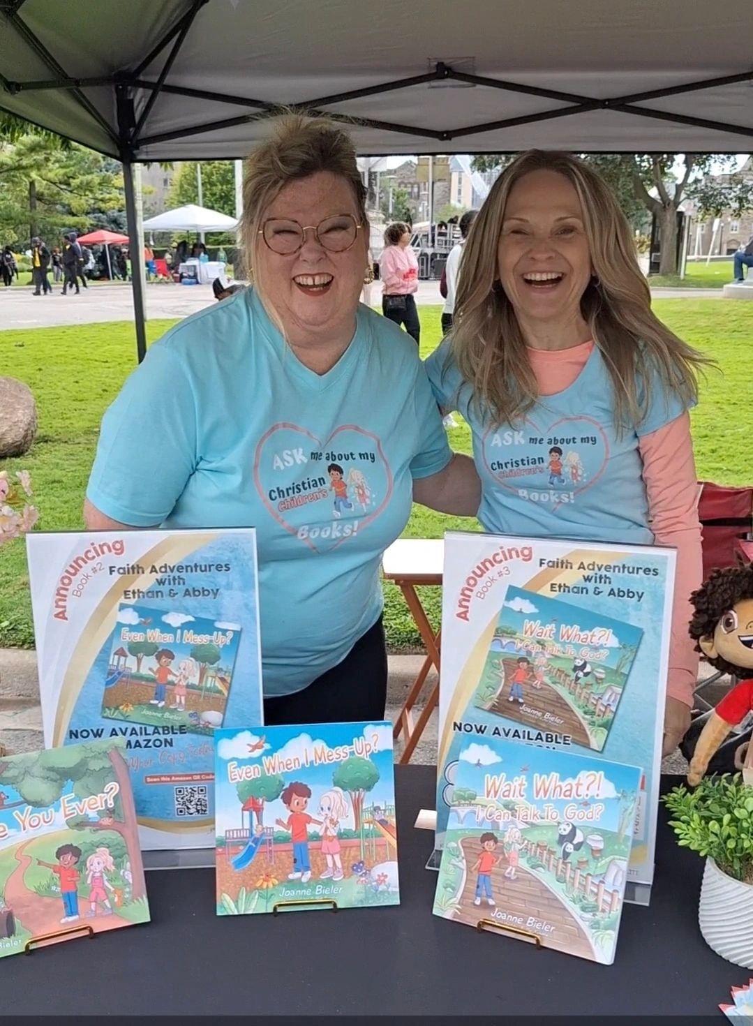Joanne and Sandra Dalziel at outdoor book table with Faith Adventures books