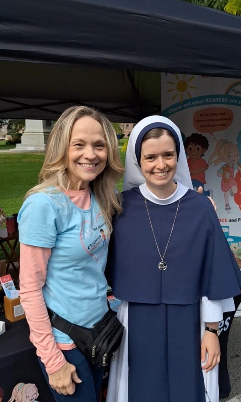 Joanne with a nun at JITC Parade 2025 booth in Toronto