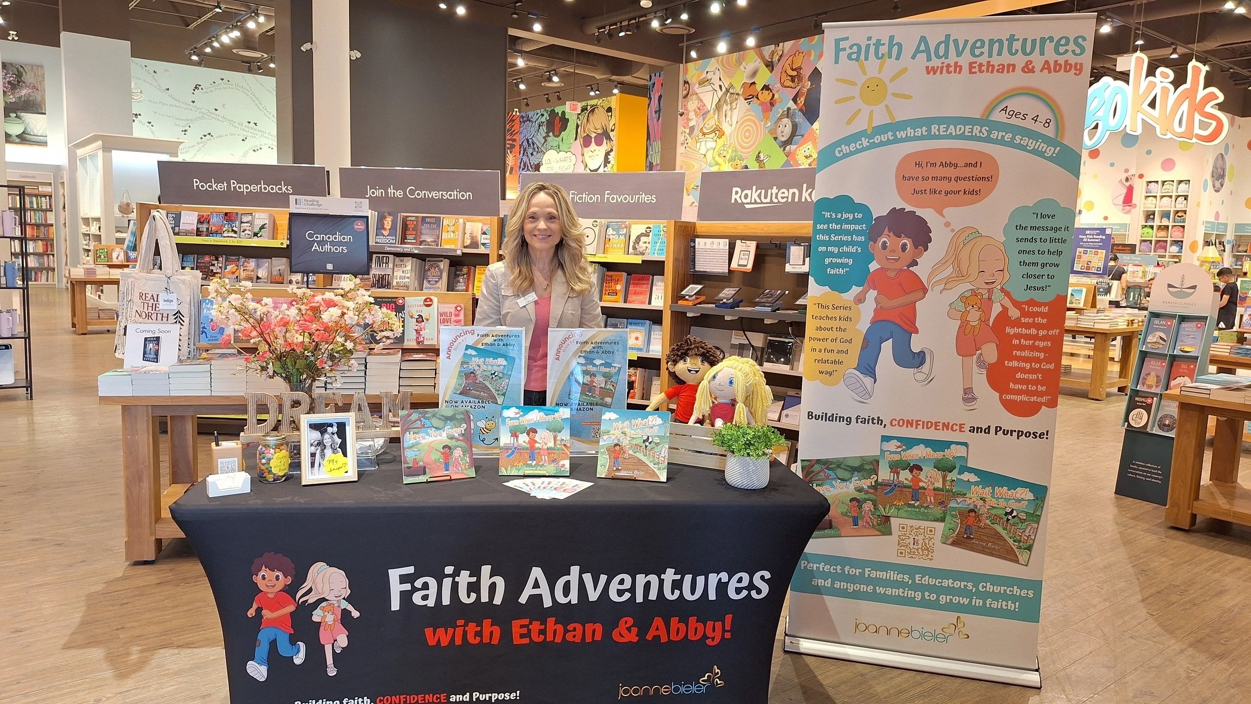 Joanne at her full Faith Adventures with Ethan and Abby author signing display at Indigo bookstore