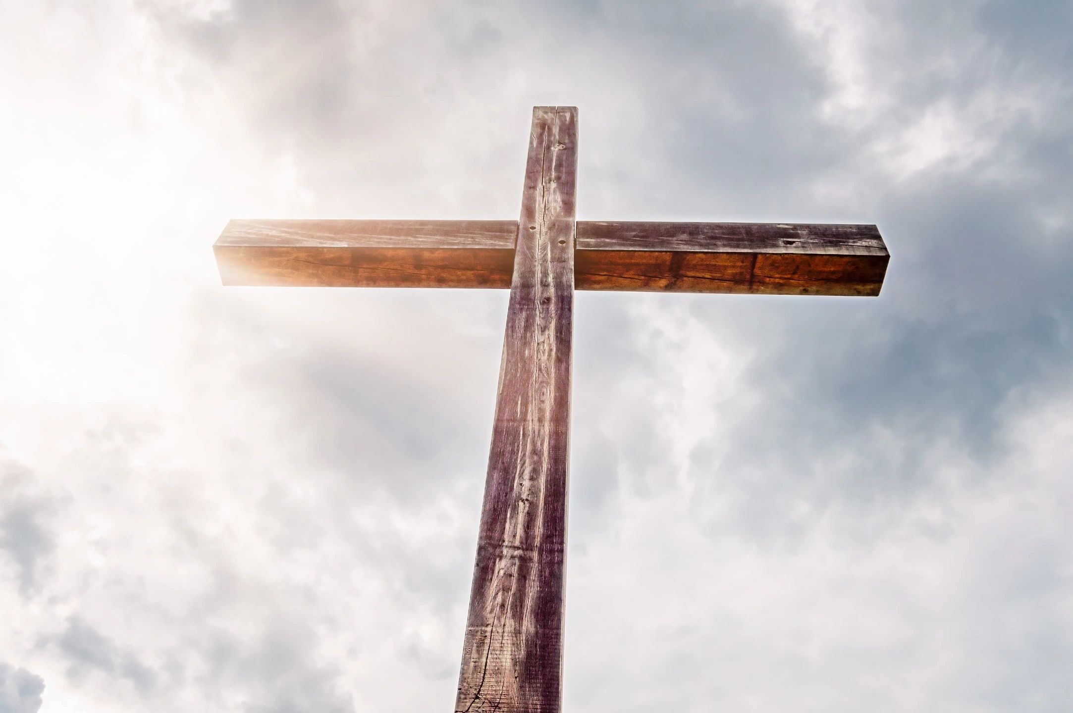 A wooden cross against a dramatic sky